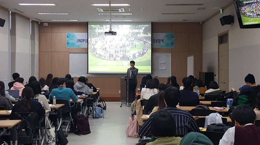 A Green Peace staff gives a lecture to students